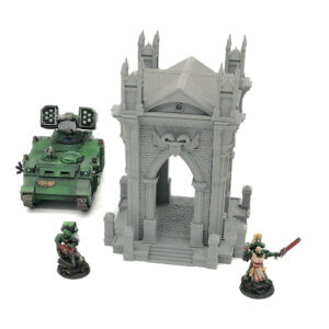 Grey 3D-printed gothic archway miniature terrain shown next to painted tabletop figures for scale