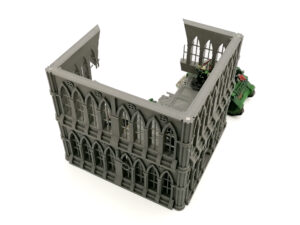 Grey 3D-printed gothic-style ruined building terrain for tabletop wargames, shown with miniature figures