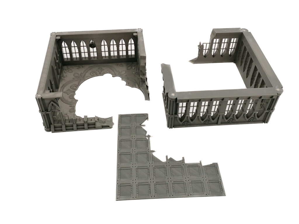 Grey modular 3D-printed gothic ruin terrain pieces, featuring two wall sections with arched windows and a tiled floor