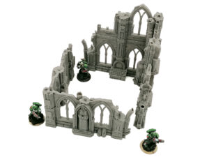 Grey 3D-printed gothic ruin wargaming terrain with arched windows, shown with miniatures for scale