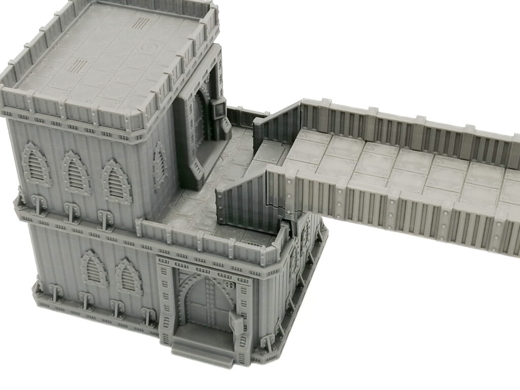 Grey 3D-printed sci-fi gothic building with an attached walkway, designed for tabletop wargaming terrain
