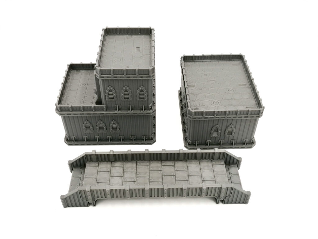 Grey 3D-printed sci-fi gothic miniature buildings and a bridge terrain piece for tabletop wargaming