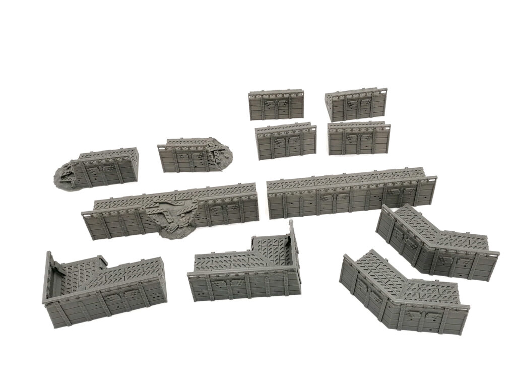 Grey 3D-printed modular sci-fi fortification wall pieces for tabletop wargaming, shown on a white background