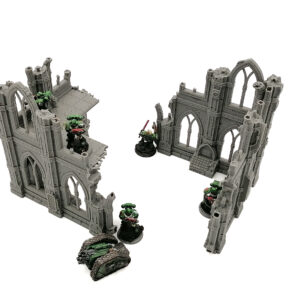 Grey 3D printed gothic ruin tabletop terrain pieces with miniature gaming figures on a white background