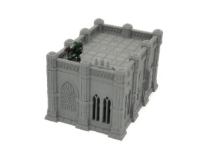 Grey 3D-printed gothic building terrain piece with a small green miniature figure on the roof for scale