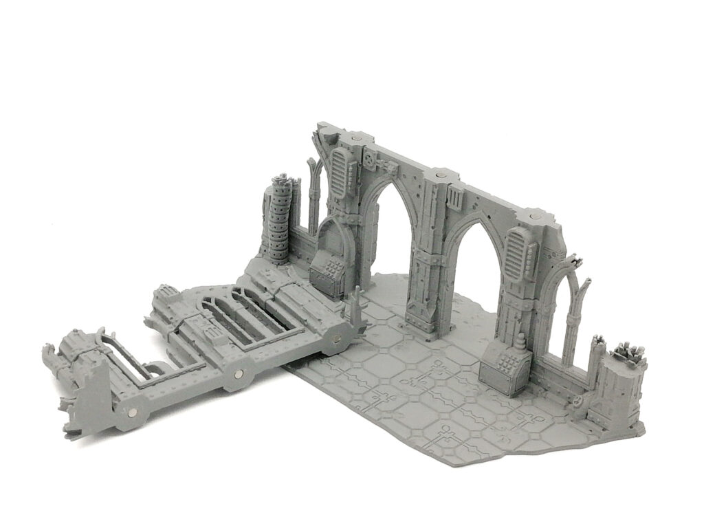 Modular grey 3D-printed gothic ruin terrain with magnetic joints for tabletop gaming, on a white background