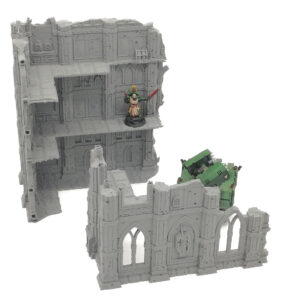 Grey 3D-printed gothic ruins terrain for tabletop wargaming, showing a multi-level building and ruined wall section