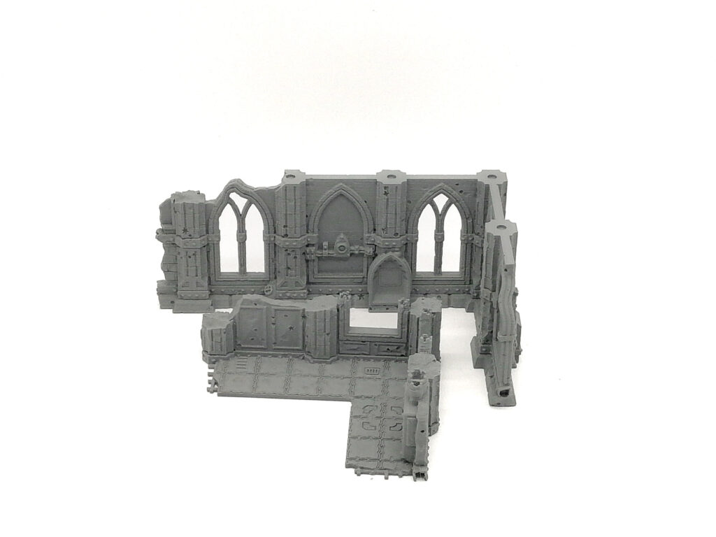 Grey 3D-printed gothic ruin miniature terrain piece with arched windows and a tiled floor for tabletop gaming
