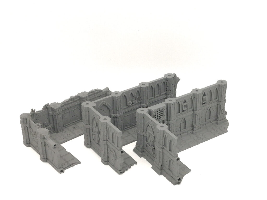 Grey 3D-printed modular gothic ruins terrain wall sections for tabletop gaming