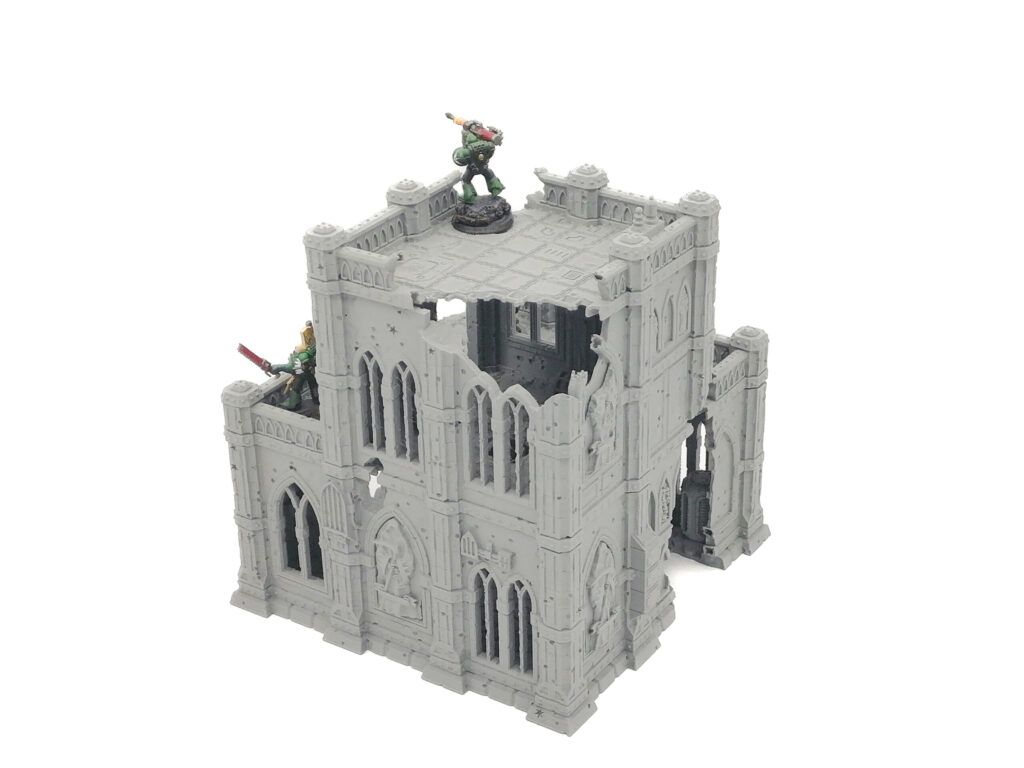 Grey 3D-printed gothic ruin terrain piece for tabletop wargaming, featuring two levels and arched windows