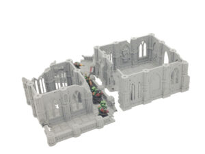 Grey 3D-printed gothic ruin tabletop terrain shown with miniature soldiers on a white background