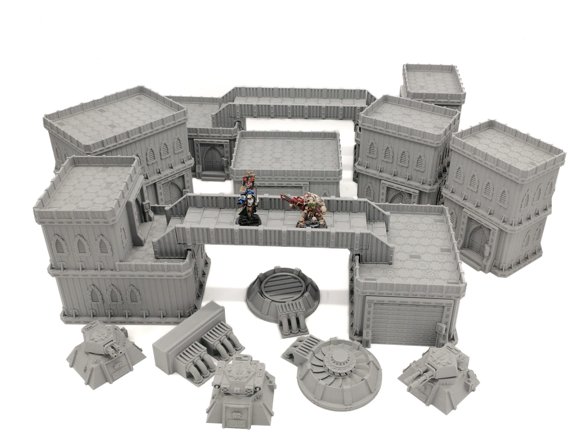 Modular grey 3D-printed sci-fi terrain set for tabletop gaming, featuring buildings, walkways, and defensive turrets