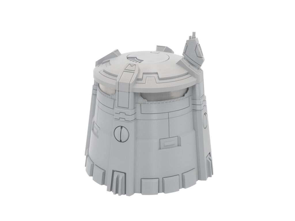 Grey 3D-printed sci-fi tower terrain miniature, isolated on a white background