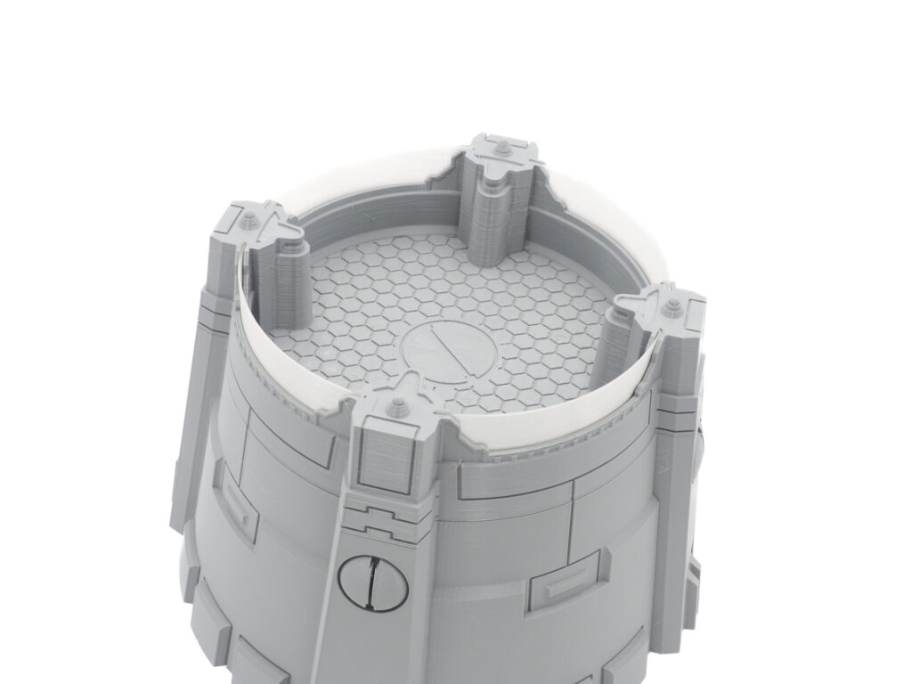 Grey 3D printed sci-fi tower terrain piece with a hexagonal grid floor and translucent plastic rim insert