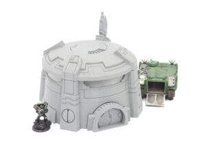 Grey 3D-printed sci-fi bunker terrain piece for tabletop gaming, shown with miniatures for scale