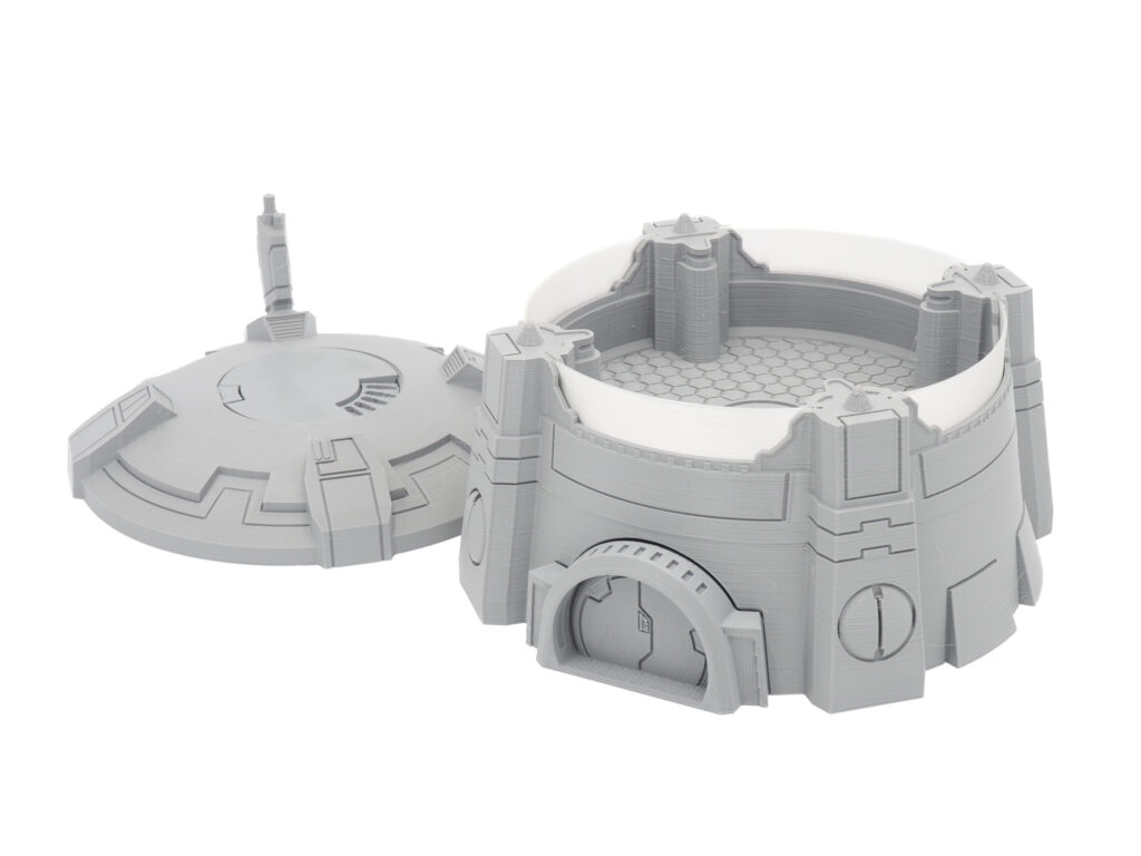 Grey 3D-printed sci-fi miniature building with a removable roof, showing a detailed hex-patterned interior floor
