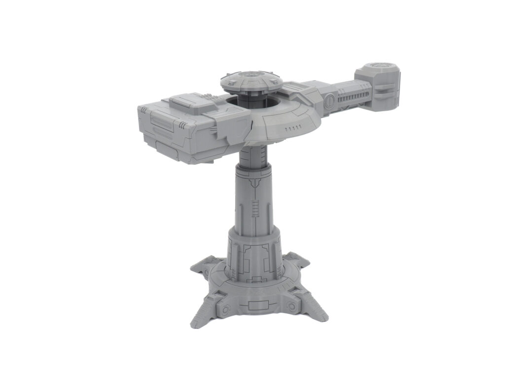 Grey 3D-printed futuristic tower miniature with a detailed pillar and top platform, on a plain white background