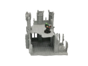 Grey 3D-printed sci-fi ruined building terrain, shown with a painted miniature figure for scale