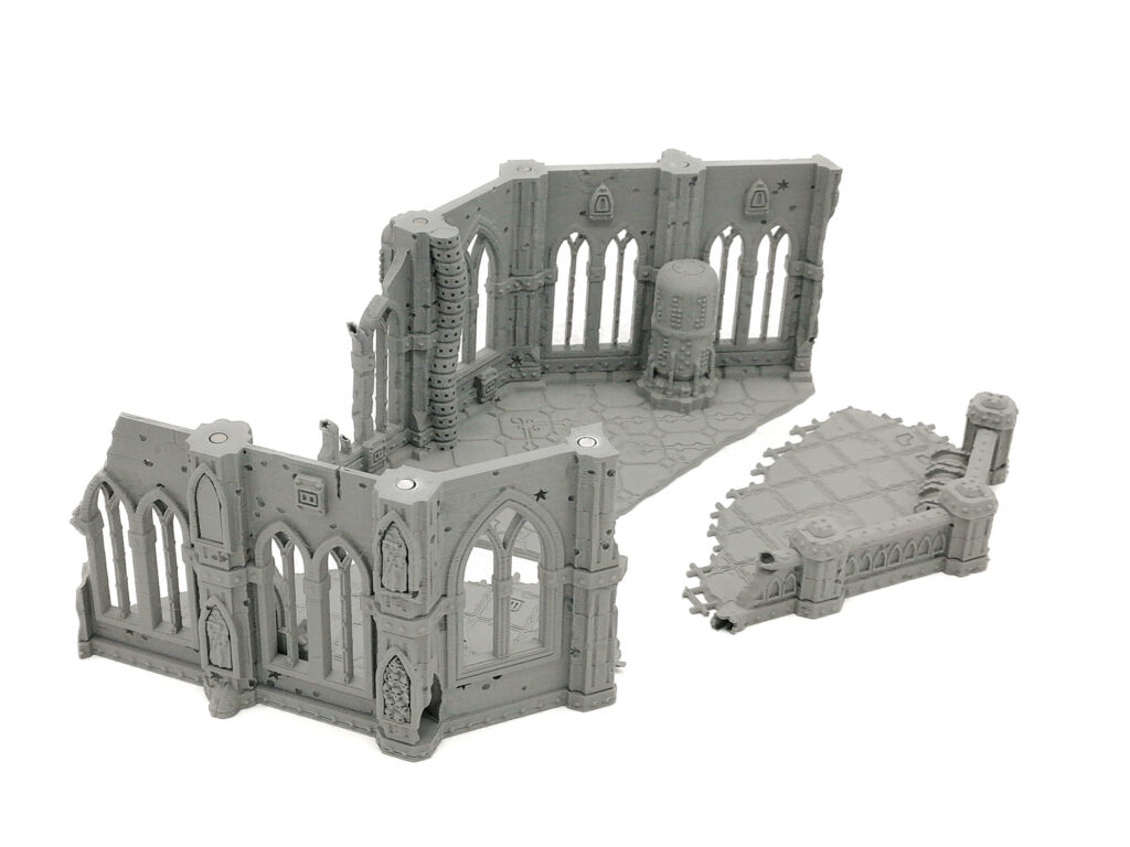 Grey 3D-printed gothic ruins miniature terrain set with arched windows and a separate floor piece
