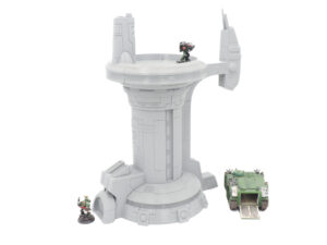 Grey 3D-printed sci-fi tower terrain for tabletop gaming, shown with miniatures and a tank for scale