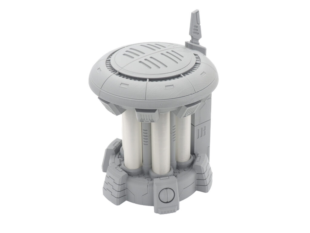 Grey 3D printed sci-fi power generator terrain model with three white core cylinders, on a white background