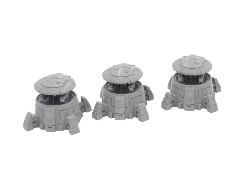 Three grey 3D-printed sci-fi turret miniatures for tabletop gaming