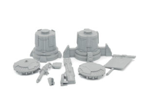Grey 3D-printed sci-fi miniature terrain and weapon parts laid out on a white background