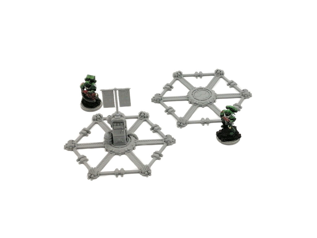Grey 3D-printed sci-fi hexagonal platforms, one featuring a communication terminal, shown with miniatures for scale