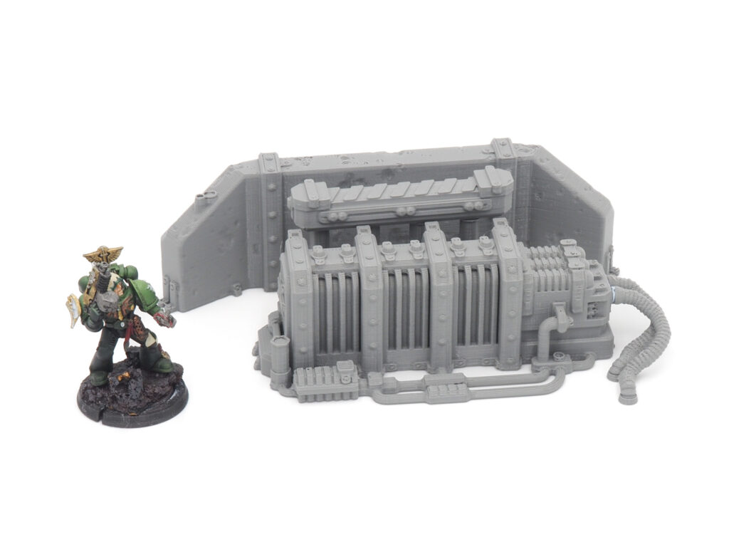 Grey 3D-printed sci-fi generator and wall terrain with a painted miniature for scale comparison