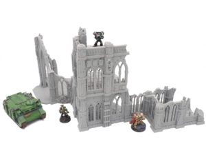 Grey 3D-printed gothic ruins terrain for tabletop wargaming, shown with sci-fi miniatures for scale