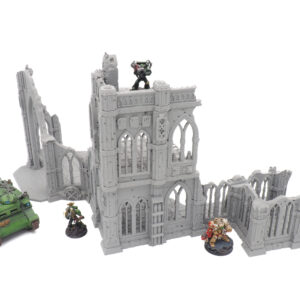 Grey 3D-printed gothic ruins terrain for tabletop wargaming, shown with sci-fi miniatures for scale