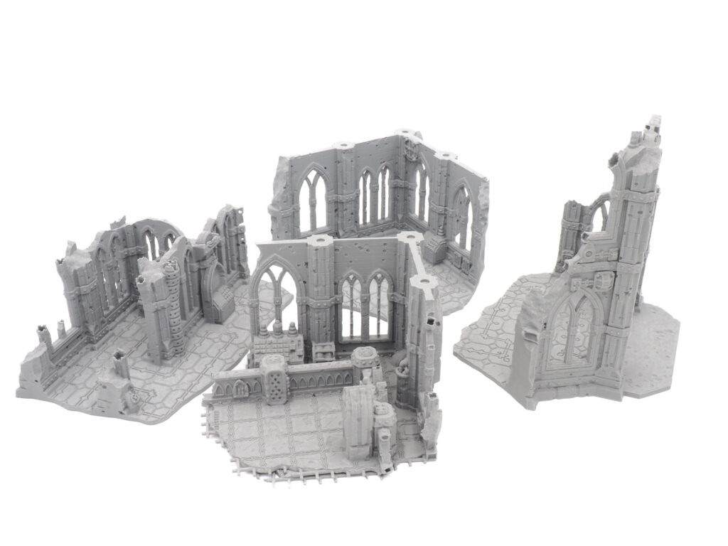 Four grey 3D-printed gothic ruin terrain pieces with arched windows, designed for tabletop wargaming