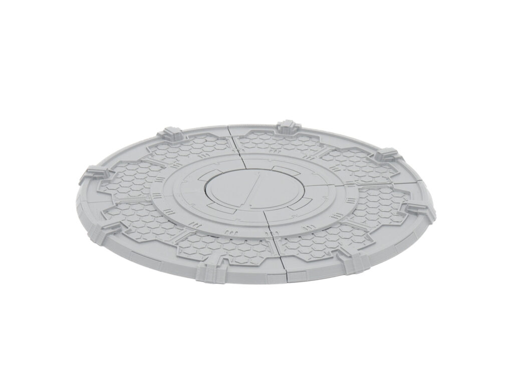 Grey 3D-printed circular sci-fi terrain platform with hexagonal patterns and panel lines