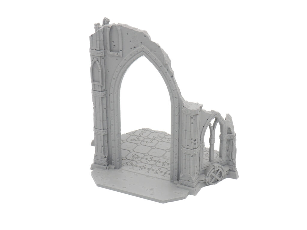Grey 3D-printed miniature terrain featuring a ruined gothic archway and tiled floor for tabletop gaming