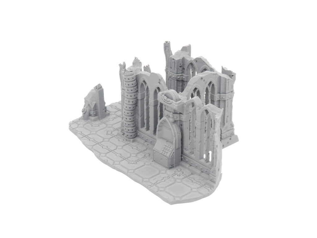 Grey 3D-printed gothic cathedral ruins miniature with arched windows and a tiled floor base