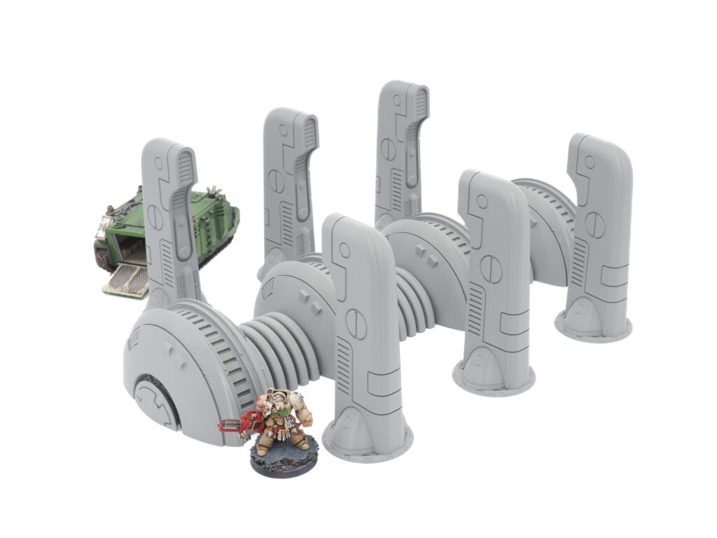Grey 3D-printed sci-fi pipeline terrain shown with miniatures for scale on a white background