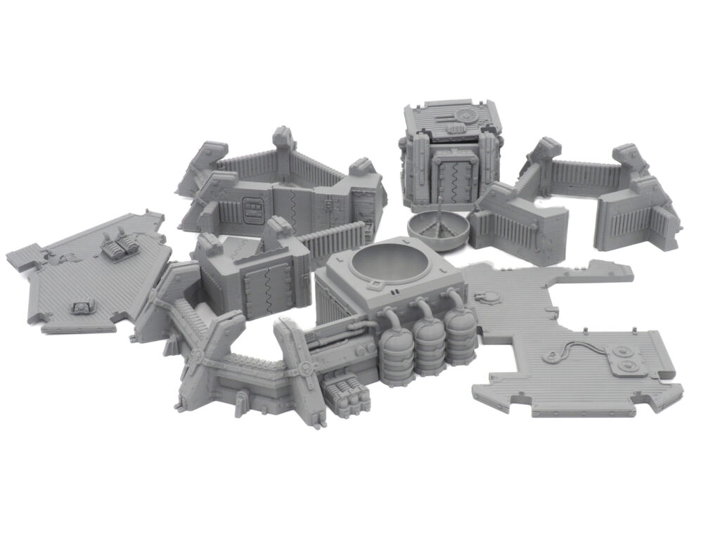 Modular grey 3D-printed sci-fi tabletop terrain set, featuring walls, platforms, and industrial components
