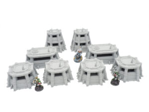Modular grey 3D-printed sci-fi miniature bunkers and pillboxes for tabletop gaming, shown with figures for scale