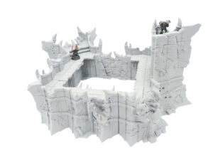 Grey 3D-printed ruined fortress walls for tabletop wargaming, shown with miniature figures for scale