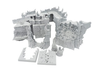 Unpainted grey 3D-printed modular tabletop terrain set featuring spiked demonic walls and ruins