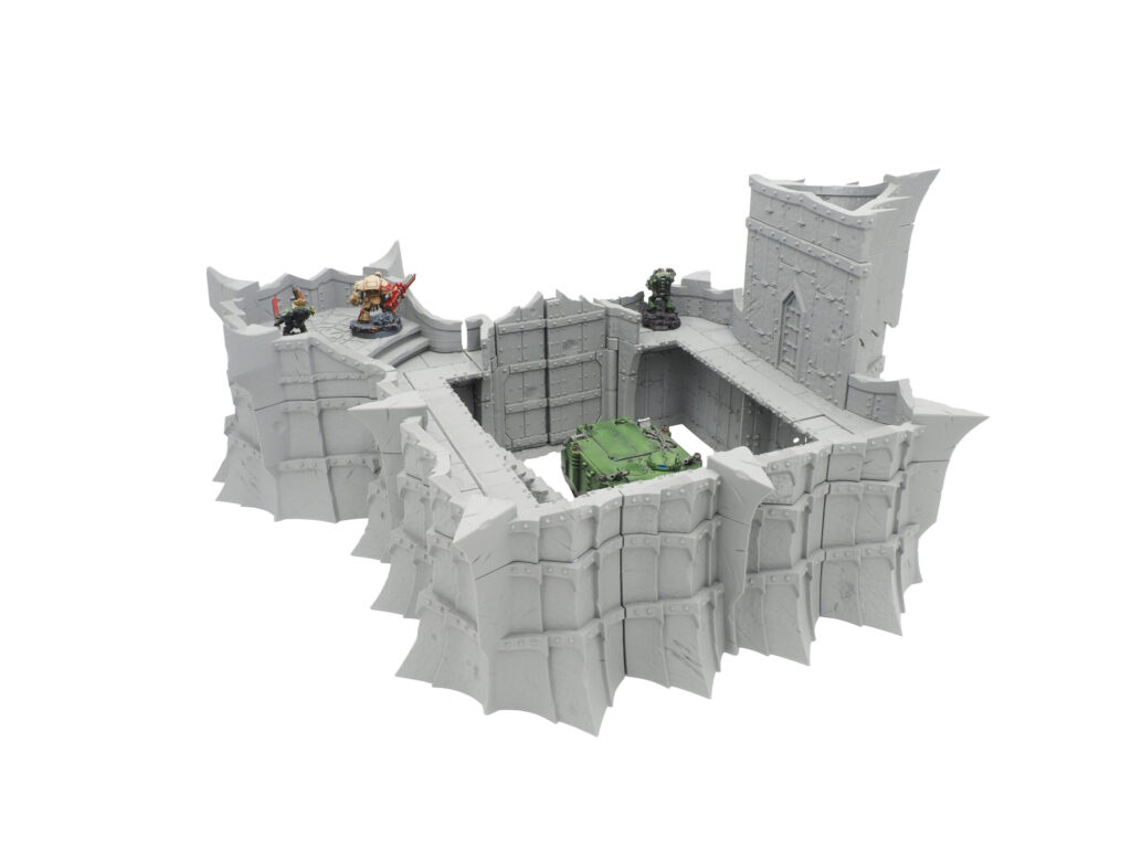 Grey 3D-printed modular fortress wall terrain for tabletop gaming, displayed with painted miniatures for scale