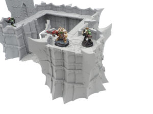Grey 3D-printed modular fortress wall terrain for tabletop wargames, shown with painted miniatures for scale