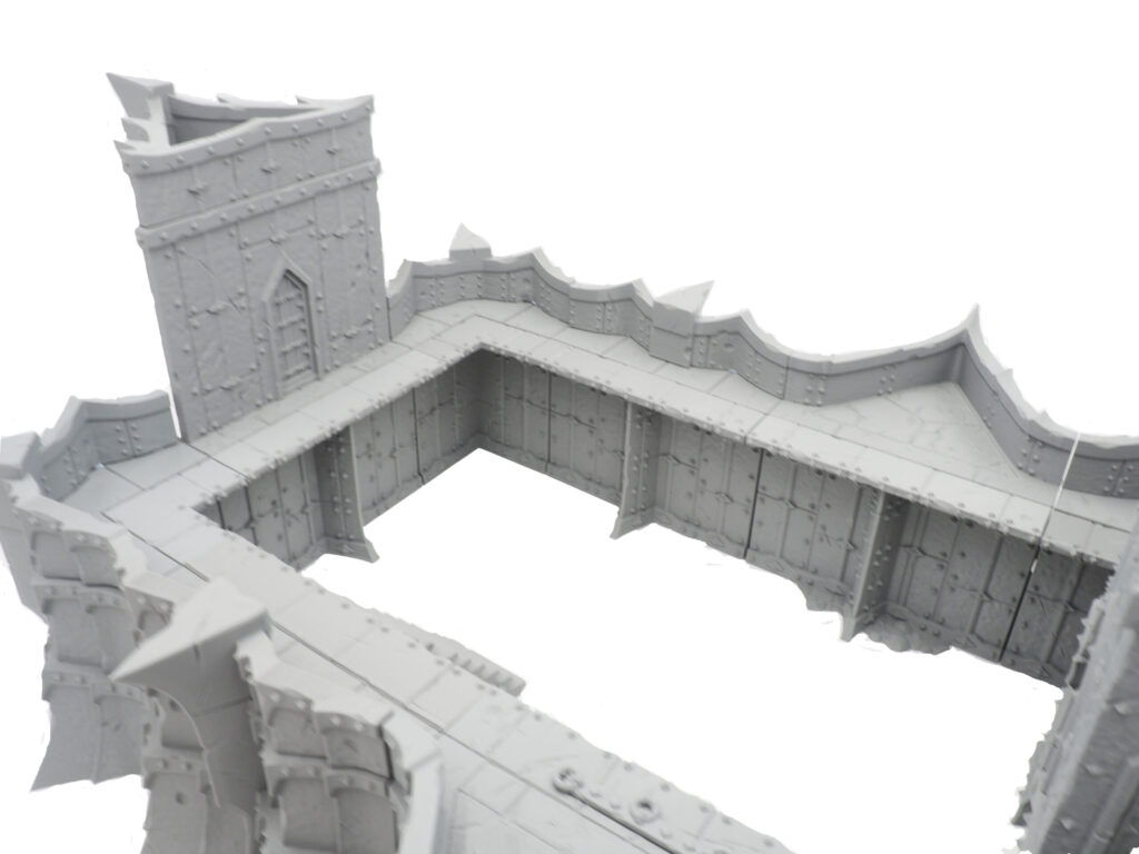 Grey 3D-printed modular fantasy fortress walls and tower assembly for tabletop gaming terrain