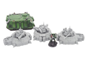 Three grey 3D-printed miniature turrets displayed next to a painted green sci-fi tank and soldier for scale