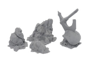 Grey 3D-printed tabletop terrain miniatures featuring rocky outcrops and a skull with an axe embedded in it