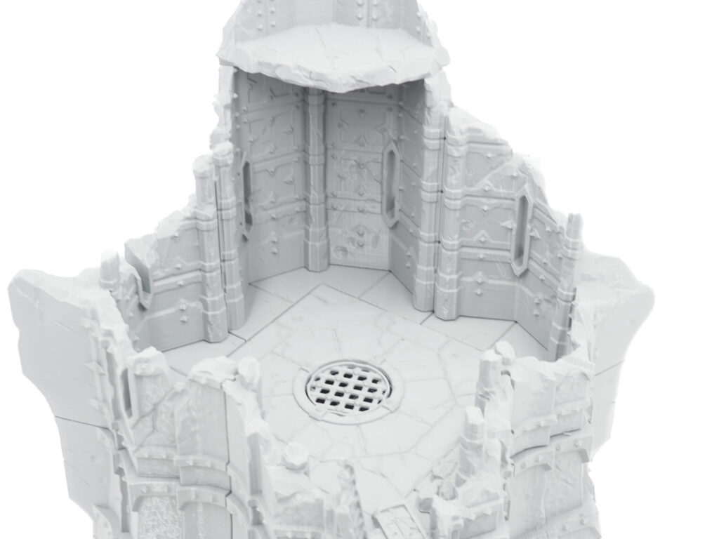 Grey 3D-printed miniature terrain showing a ruined gothic tower interior with a circular floor grate