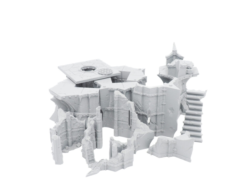 Grey 3D-printed fantasy ruins terrain set with crumbling walls and stairs on a white background