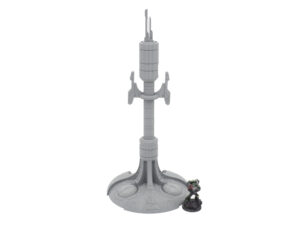 Grey 3D-printed sci-fi antenna tower terrain piece shown next to a painted miniature figure for scale