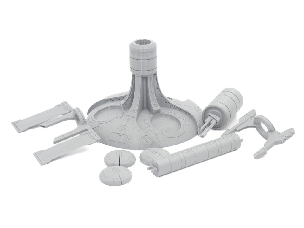 Grey 3D-printed plastic components for a sci-fi model kit arranged on a plain white background