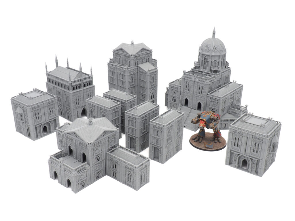 Unpainted grey 3D-printed gothic cathedral terrain set with a painted miniature mech for scale